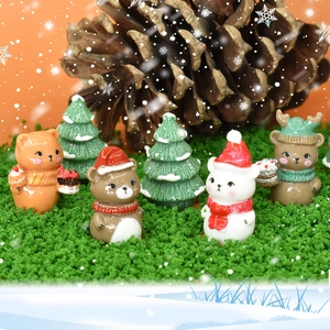 Christmas miniature set with resin bear, cat, snowman and snow-covered trees on green moss