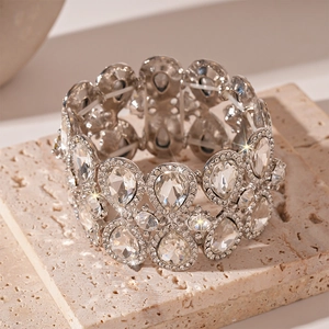 Detailed close-up of wide stretch bracelet featuring pear-cut crystals on stone