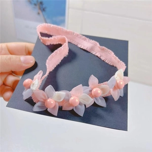 Detail of pink chiffon flowers and glossy pearls on the soft lace headband