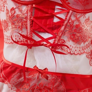 Close-up of white sheer mesh lace corset with red floral embroidery and satin ribbon ties