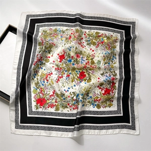 Detail of floral printed satin square scarf with vintage flowers and smooth texture