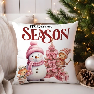 Cozy Christmas pillowcase detail featuring pink winter art on white sofa setting