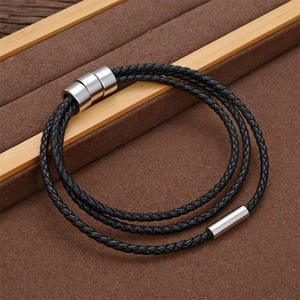 Detail shot of multi-layer black braided leather bracelet with magnetic steel clasp