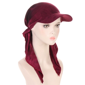 Detail of dark red velvet turban hat showing the brim and stylish tie-back straps
