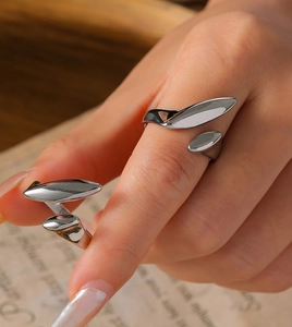 Macro shot of minimalist silver open ring with polished irregular geometric fluid design