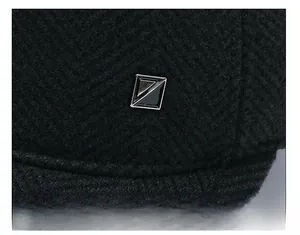 Macro shot of black herringbone wool baseball cap featuring a square metallic decorative buckle