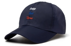 Detail of navy quick-dry baseball cap with letter embroidery and laser-cut side vents