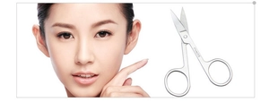 Close-up of stainless steel beauty scissors showing the sharp blade and metal texture