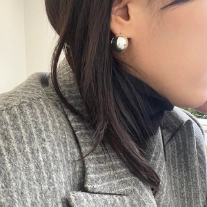 Close-up of a high-polished S925 silver ball earring on a woman's ear in a daily setting