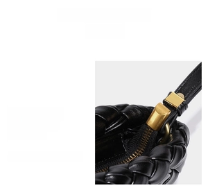 Detail of woven black leather bag featuring premium custom gold hardware and zipper