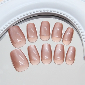 Handmade cat eye press-on nails in sheer red coffee tone on decorative mirror base