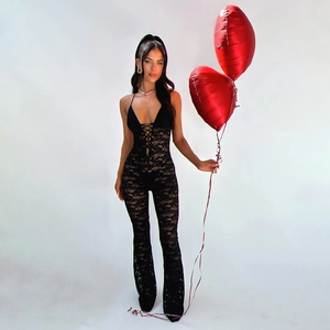 Detailed view of black floral lace jumpsuit with plunging halter neck and flared leg style