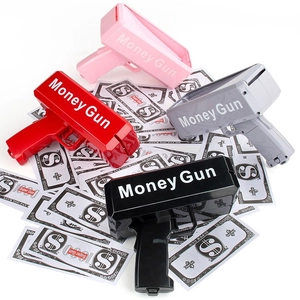Electric Money Gun toy in pink red grey and black colors on stack of prop bills