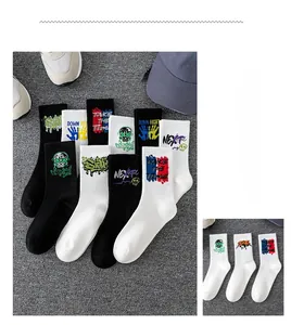 Detail of graffiti style mid-calf athletic socks with text prints and cotton texture