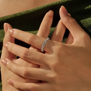 Elegant S925 sterling silver eternity ring with VVS1 moissanite stones on a finger