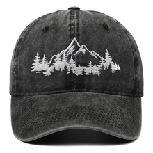Detailed embroidery of mountains on a dark grey vintage washed cotton baseball cap