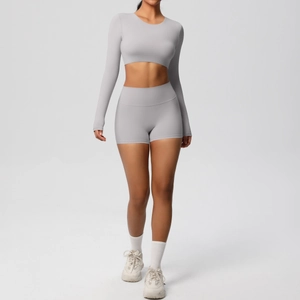 Detail of light gray high-waisted shorts and long sleeve crop top fitness yoga set