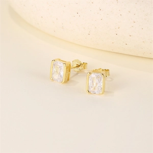 Macro shot of S925 sterling silver hallmark and rectangle zircon on gold stud earrings