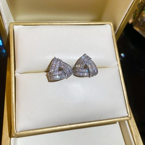Detailed view of silver triangle stud earrings with shimmering pave-set cubic zirconia crystals