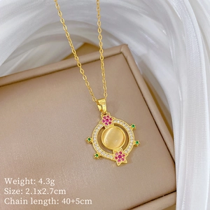 Macro view of gold cat eye stone pendant with pink zircon star details on silk
