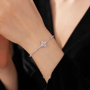 Sparkling zircon flower adjustable bracelet with diamond-encrusted chain on model's wrist