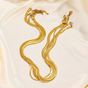 Minimalist 18K gold plated stainless steel snake chain necklace on silk background