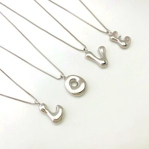 Detailed view of silver puffed balloon LOVE letter pendants on sleek box chains