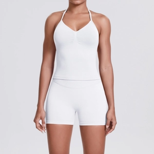 Detail view of white seamless knitted yoga set with V-neck top and high waist sports shorts