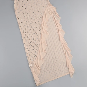 Close-up of pink layered mesh dress featuring ruffle edges and sparkling rhinestone details