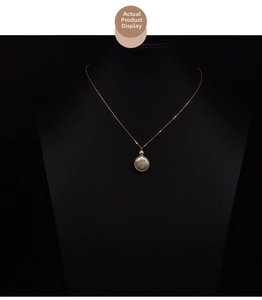 Detailed macro view of a gold-rimmed freshwater pearl pendant on a black bust