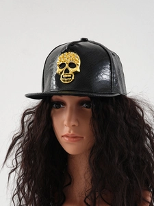 Detail of black PU leather baseball cap featuring a golden 3D punk skull and snake texture