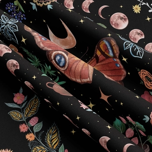 Close-up of printed fabric with mystic moth, moon phase and botanical patterns