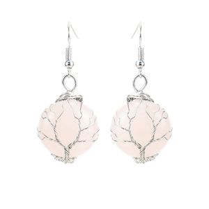 Detail of handmade silver wire wrapped rose quartz tree of life earrings on white back