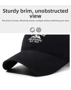 Detail of curved baseball cap brim showing durable cotton fabric and mountain embroidery