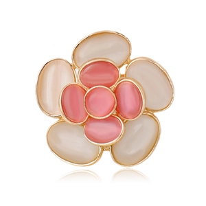 Detailed view of flower brooch with opal-like petals in pink and white on gold base