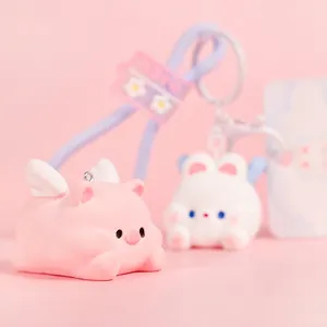 Cute flying pig and bunny keychains with purple rubber straps and silver metal rings