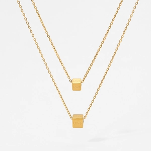 Double-layered gold necklace with two cubic pendants featuring Love engravings