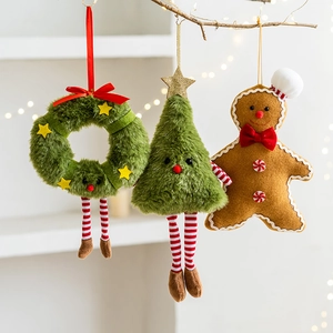 Christmas plush wreath, star and gingerbread man ornaments hanging on a cozy branch