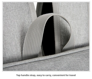 Close-up of the reinforced top handle strap on a gray insulated picnic backpack