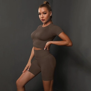 Close-up of seamless dark brown yoga set featuring high-waisted shorts and crop top