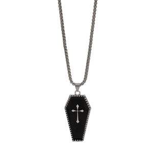 Detail of gothic coffin pendant with silver cross and bead texture on a box chain