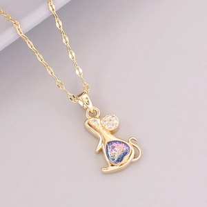 Macro shot of 18K gold-plated mouse pendant with sparkling glitter and clear rhinestones
