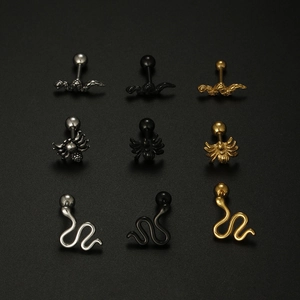 Detailed set of spider and snake stud earrings in silver, gold, and black steel finishes