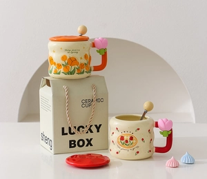Detail of tulip pattern ceramic mug set with lids, spoons and matching gift bag