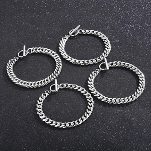 Handmade stainless steel Cuban link bracelets with OT toggle clasps on a dark background