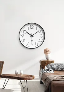 Detail of a minimalist 12-inch radio clock showing automatic time setting icon on white dial