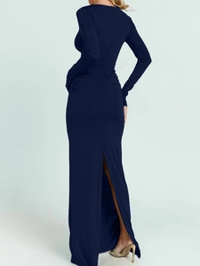 Detail view of the elegant navy blue ruched back and slit hem on the slim maxi dress