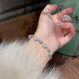 Close-up of zircon flower chalcedony bracelet with star-shaped links on wrist