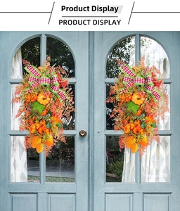 Detail of autumn wreath swags with pumpkins and maple leaves on blue doors
