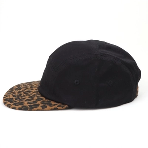 Detail of 5-panel camper hat with leopard print brim and metal side eyelets